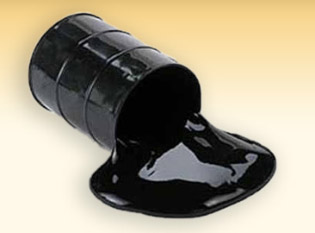 A drum of bitumen tipped over, the bitumen pooled beside it